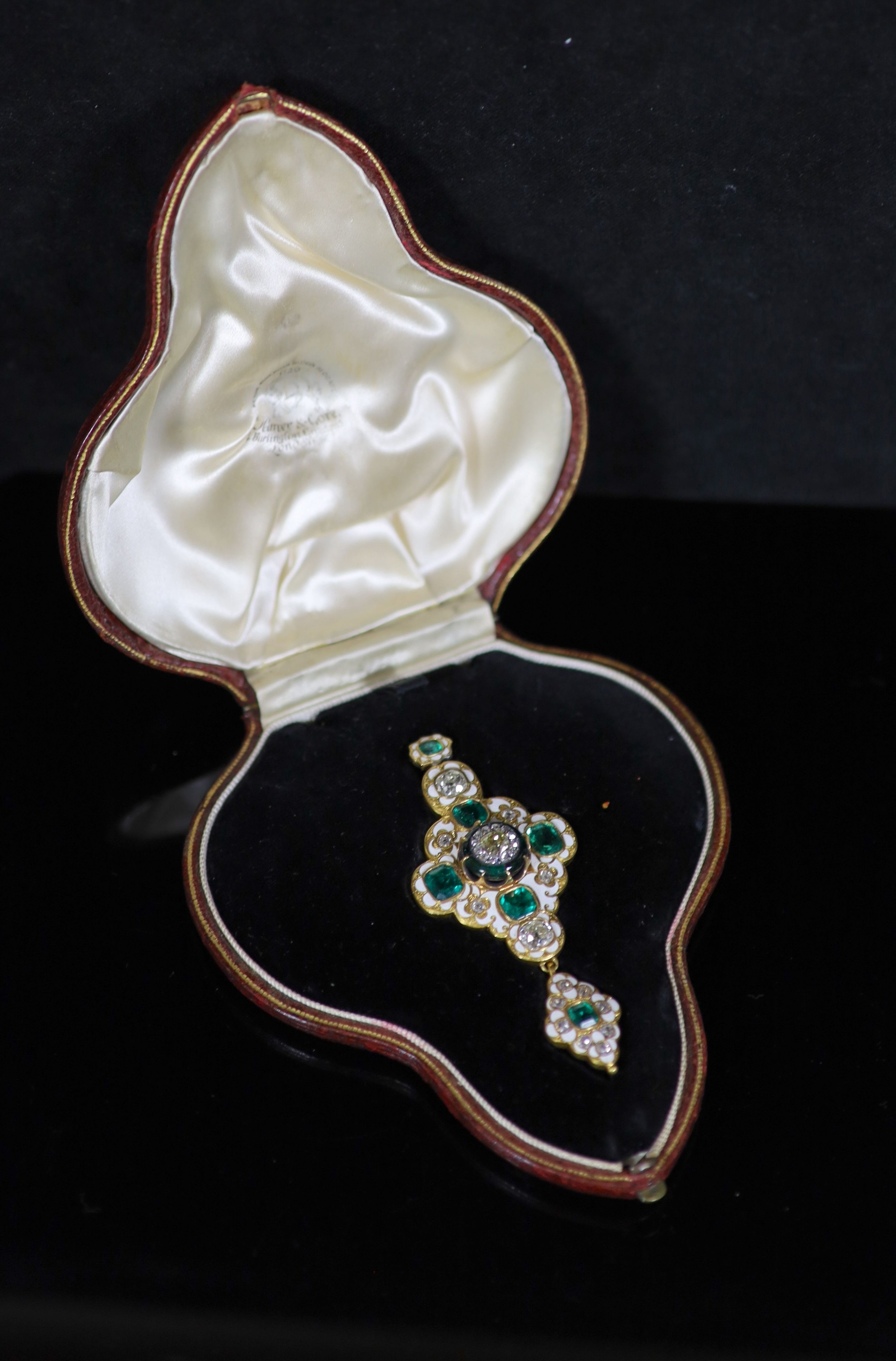 A good Victorian gold, white enamel, emerald and diamond drop pendant